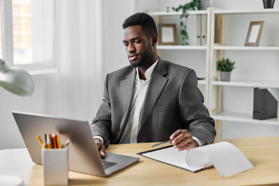 Young man working at desk in office