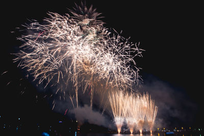 Low angle view of firework display at night