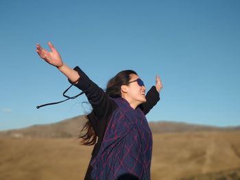 Full length of woman standing against clear sky