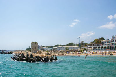 Panoramic view of sea and buildings against sky