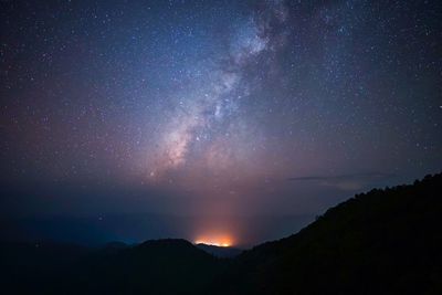 Scenic view of silhouette mountain against sky at night