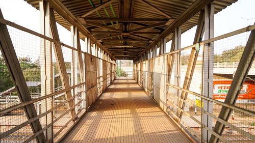 Railway station foot over bridge, inside view of station corridor, and sun ray coming