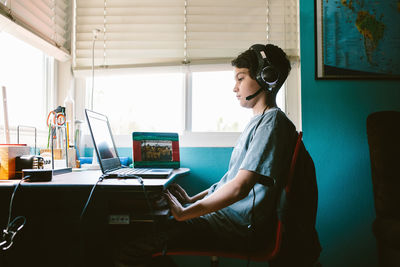 Boy stares at the screen of his laptop during a zoom class