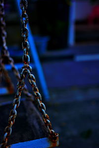 Close-up of rusty swing chain