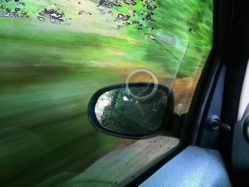 Close-up of reflection of car on glass window