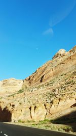 Scenic view of rocky mountains against blue sky