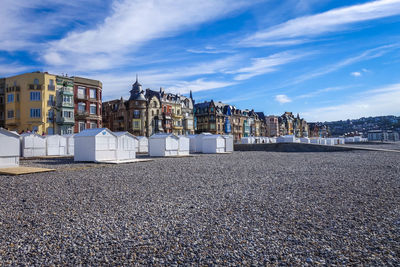 Panoramic view of beach and buildings against sky