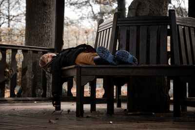 Rear view of man sitting on bench