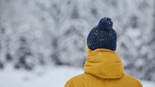 Rear view of man wearing warm clothing during winter