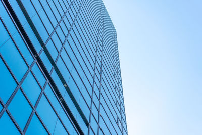 Low angle view of modern building against clear blue sky