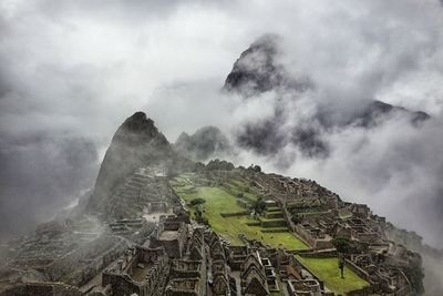 Mountain range against cloudy sky