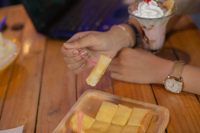 High angle view of woman eating food on table