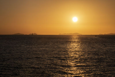 Scenic view of sea against orange sky