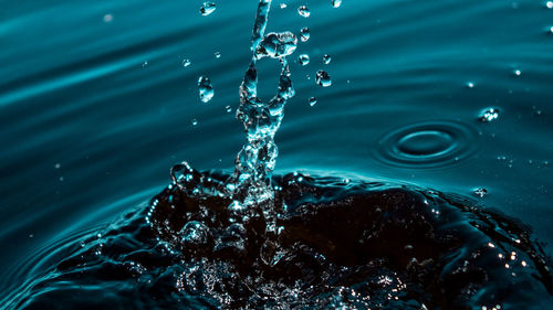 Close-up of drop splashing on water