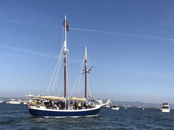 Sailboat sailing on sea against sky