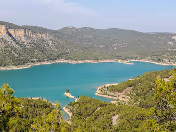 High angle view of sea and mountains against sky