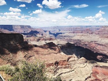 Aerial view of dramatic landscape against cloudy sky