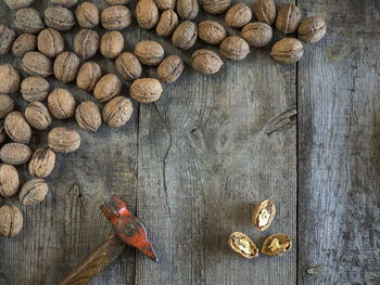 High angle view of walnuts with hammer on table