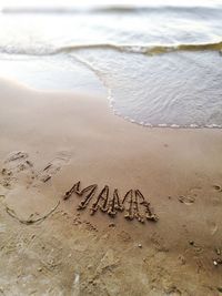 High angle view of text on beach