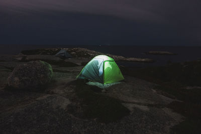 Couple talking in a tent while camping at pollys cove, nova scotia, canada