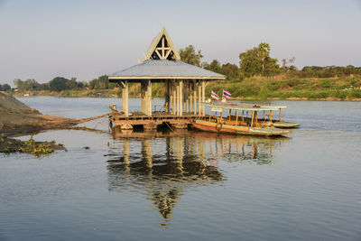 Gazebo in lake against sky