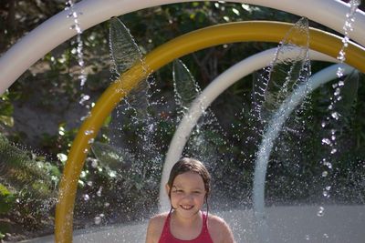 Full length of happy boy playing in water