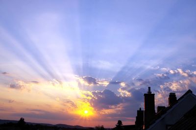 Silhouette buildings against sky during sunset