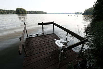 Pier on lake against sky