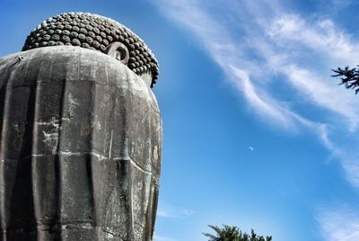 Low angle view of statue against blue sky