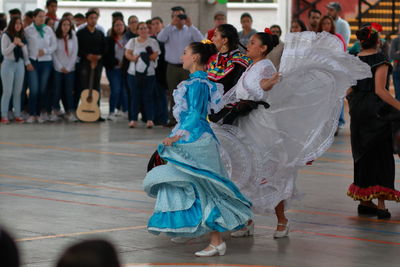 Group of people dancing at music concert