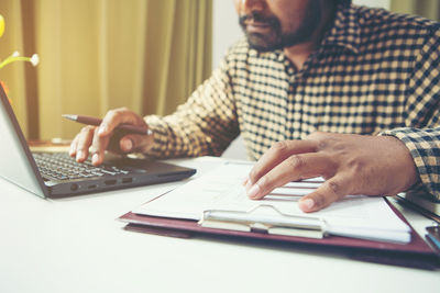 Man using laptop on table