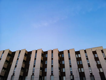 Low angle view of building against clear blue sky