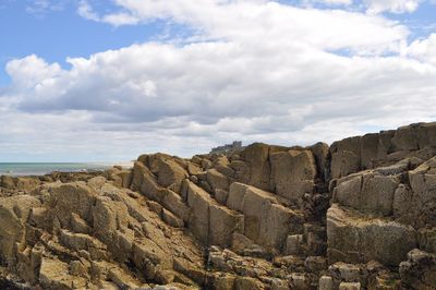 Rock formations on landscape against sky