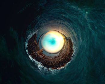 Digital composite image of sea seen through hole