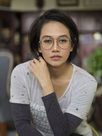 Portrait of young woman posing indoors