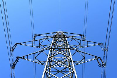 Low angle view of electricity pylon against clear sky