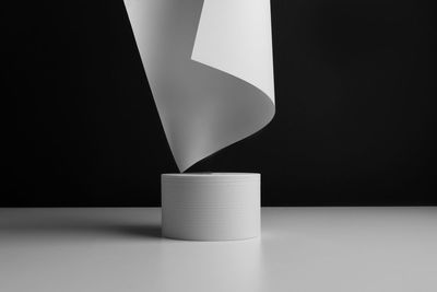 Close-up of electric lamp on table against black background