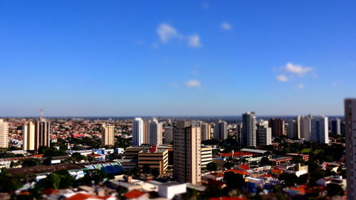 Tilt-shift image of cityscape against blue sky