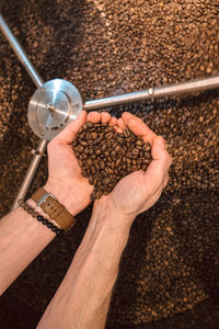 Coffee beans in a mans hand in heart shape. with color matching wristband and watchband