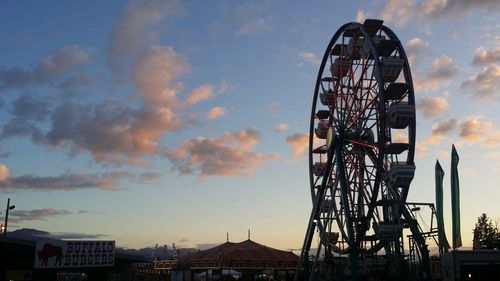 Low angle view of ferris wheel against sky