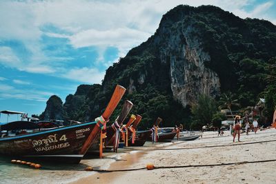 Boats moored on beach against sky