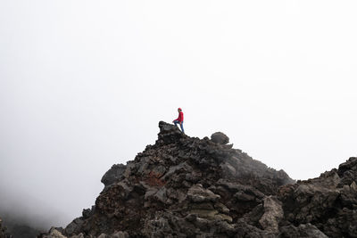 Rear view of man climbing on mount etna