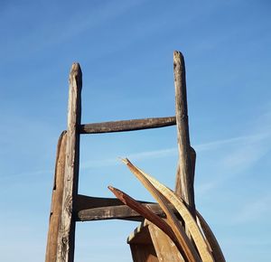 Low angle view of wooden bridge against sky