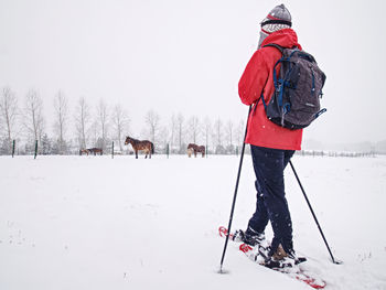 Rear view of people on snow field