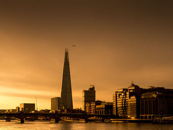 View of city at waterfront during sunset