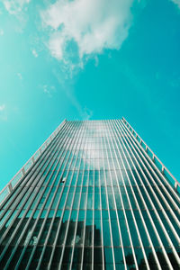 Low angle view of modern building against blue sky