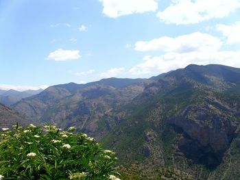 Scenic view of mountains against cloudy sky