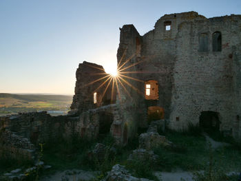 Old building against sky during sunset