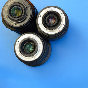 Directly above shot of various lenses on blue background