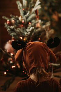 Rear view of man with christmas tree